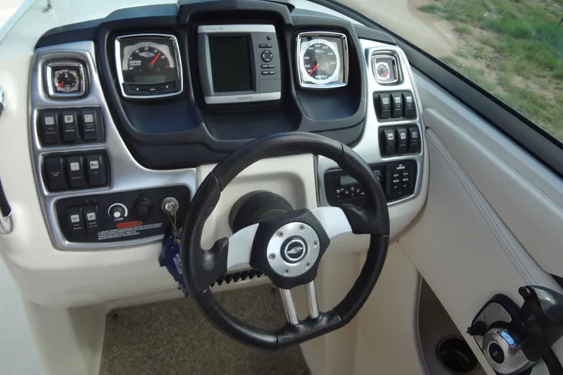 Slide: The Image of Steering console of 2008 Chaparral 276 SSX boat with gauges and controls. - 26