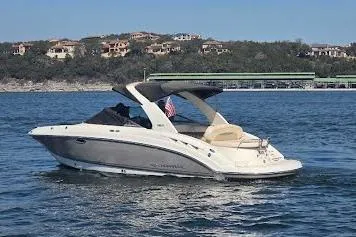 Slide: The Image of 2008 Chaparral 276 SSX boat cruising on a lake with scenic shoreline. - 3