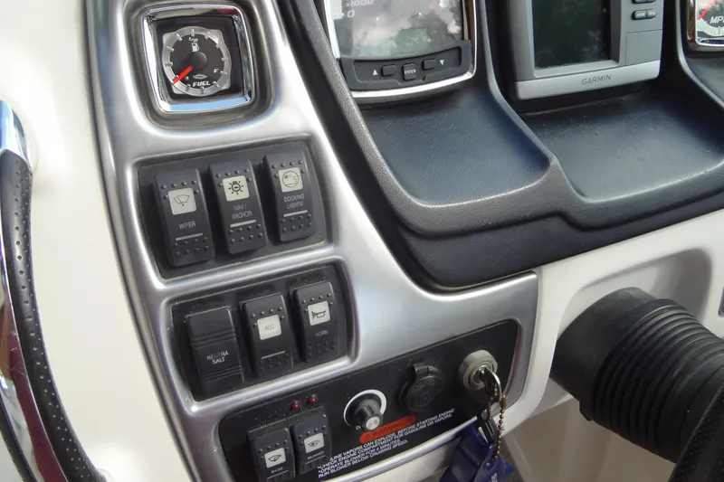 Slide: The Image of Dashboard controls of a 2008 Chaparral 276 SSX boat with switches and gauges. - 30