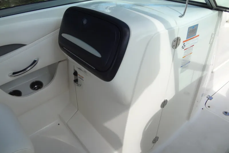 Slide: The Image of 2008 Chaparral 276 SSX boat interior with storage compartment and cup holders. - 33