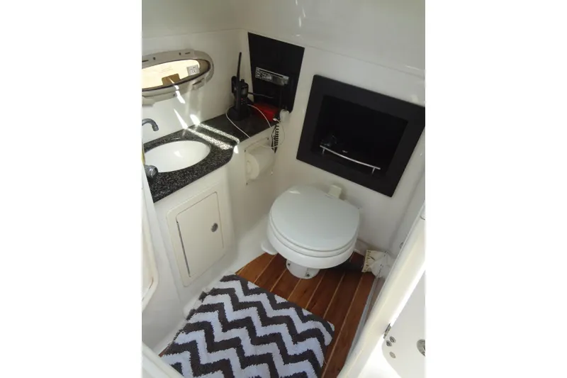 Slide: The Image of 2008 Chaparral 276 SSX boat bathroom with sink, toilet, and chevron rug. - 34