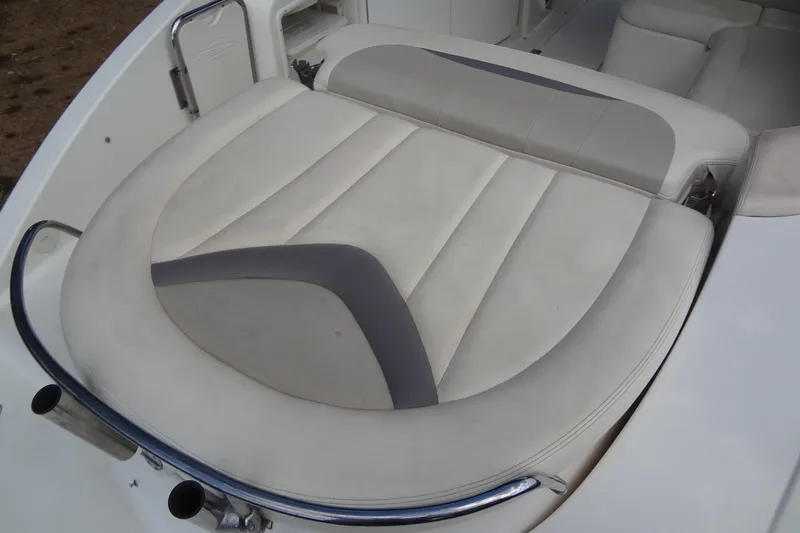 Slide: The Image of 2008 Chaparral 276 SSX boat interior with white and gray cushioned seating. - 38