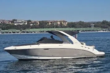 Slide: The Image of 2008 Chaparral 276 SSX boat cruising on a calm lake with scenic background. - 4