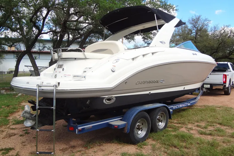 Slide: The Image of 2008 Chaparral 276 SSX boat on trailer, parked outdoors near trees. - 7