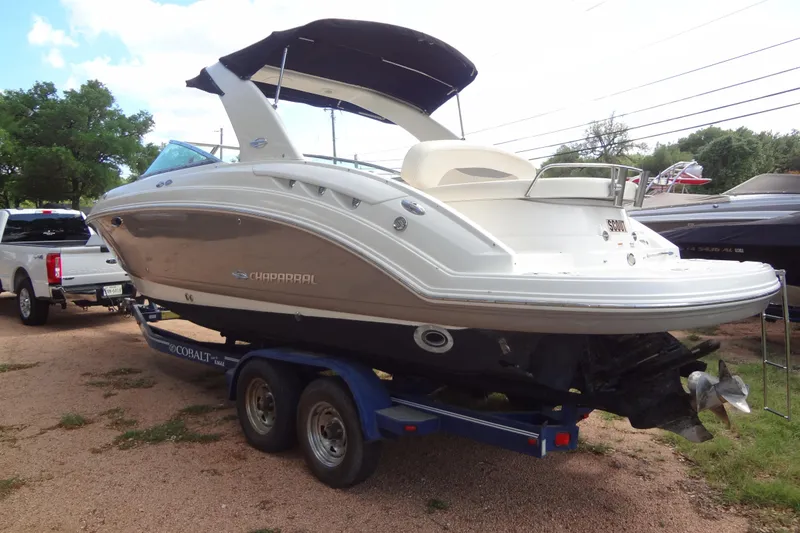 Slide: The Image of 2008 Chaparral 276 SSX boat on trailer, parked outdoors. - 9