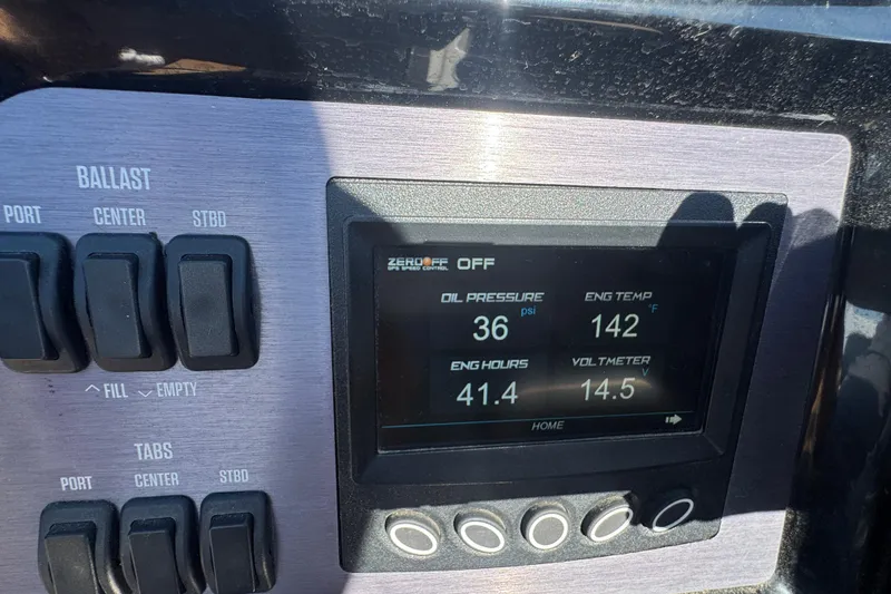 Slide: The Image of Dashboard of 2021 MasterCraft NXT24 showing engine metrics and ballast controls. - 14