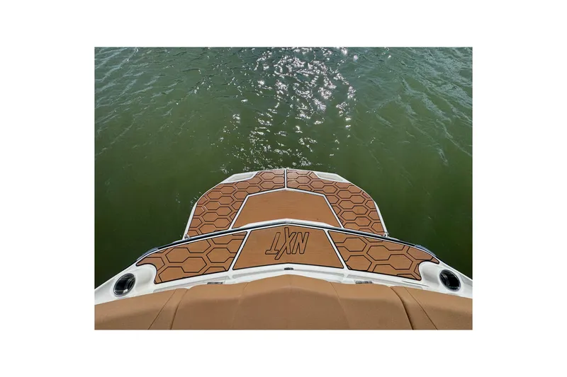 Slide: The Image of 2021 MasterCraft NXT24 boat deck with hexagonal pattern on water. - 22