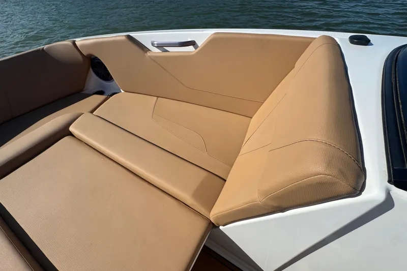Slide: The Image of 2021 MasterCraft NXT24 boat interior with tan seating and water view. - 9