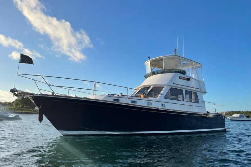 Slide: The Image of 1987 Lyman-Morse Hunt 42 yacht on calm water under clear blue sky. - 10
