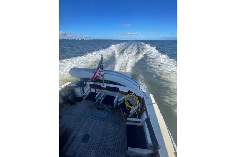 Slide: The Image of A 1987 Lyman-Morse Hunt 42 boat cruising on open water under a clear blue sky. - 14