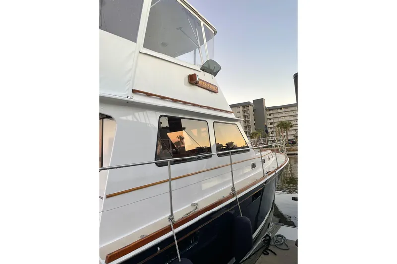 Slide: The Image of 1987 Lyman-Morse Hunt 42 yacht docked at sunset, reflecting buildings. - 15