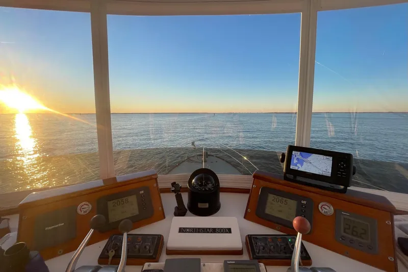 Slide: The Image of Cockpit view from 1987 Lyman-Morse Hunt 42 boat at sunset on open water. - 17