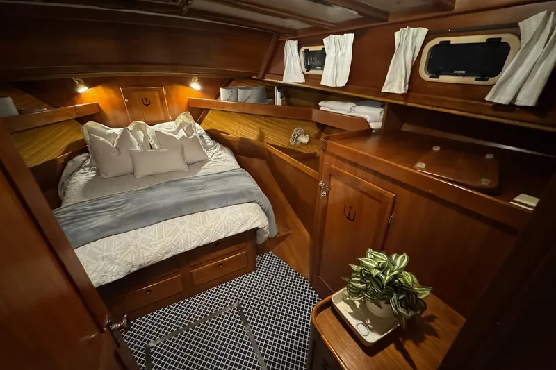 Slide: The Image of Luxurious cabin interior of 1987 Lyman-Morse Hunt 42 yacht with cozy bed and wooden furnishings. - 2