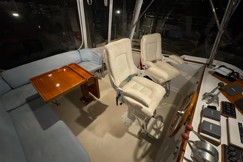 Slide: The Image of Interior of 1987 Lyman-Morse Hunt 42 yacht with helm chairs and wooden table. - 23