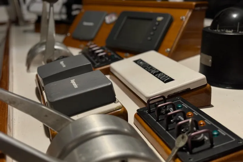 Slide: The Image of Control panel of a 1987 Lyman-Morse Hunt 42 boat with various switches and instruments. - 24