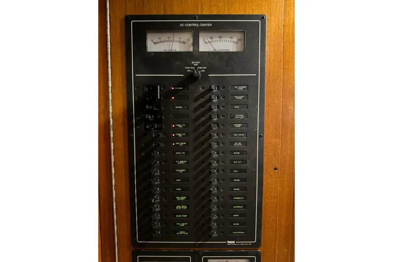 Slide: The Image of Electrical control panel on 1987 Lyman-Morse Hunt 42 boat, featuring switches and gauges. - 29