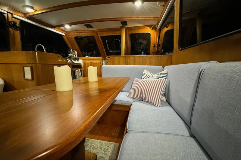 Slide: The Image of Interior of 1987 Lyman-Morse Hunt 42 yacht with cozy seating and wooden table. - 3