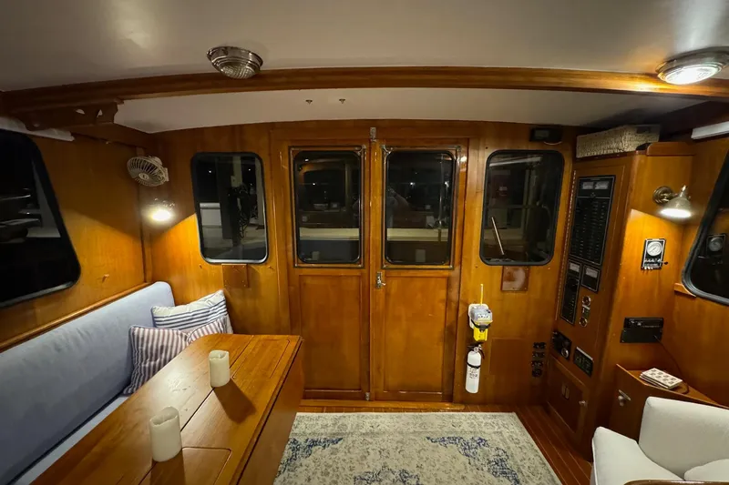 Slide: The Image of Interior of 1987 Lyman-Morse Hunt 42 yacht with wooden paneling and cozy seating area. - 30