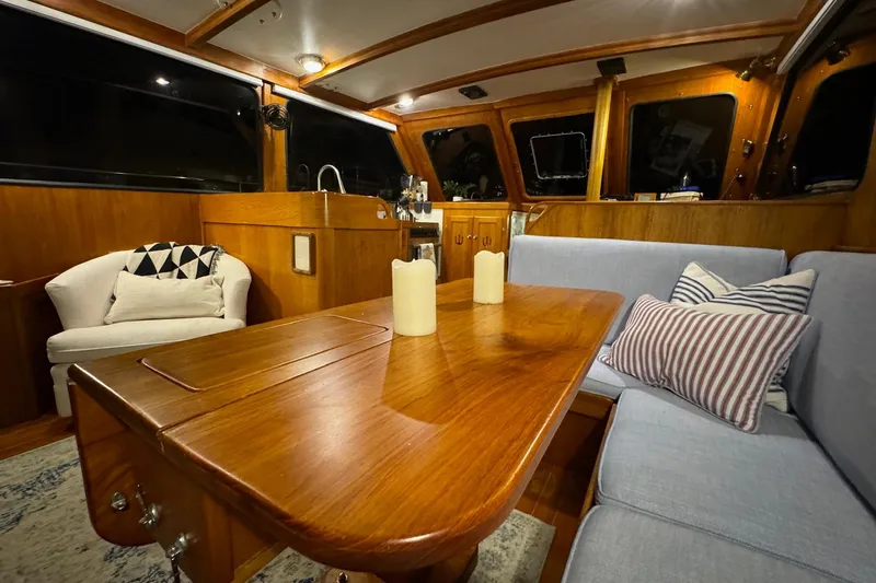 Slide: The Image of Interior of 1987 Lyman-Morse Hunt 42 yacht with wooden table and cozy seating. - 31