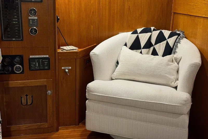 Slide: The Image of Cozy seating area on 1987 Lyman-Morse Hunt 42 yacht with control panel and plush chair. - 33