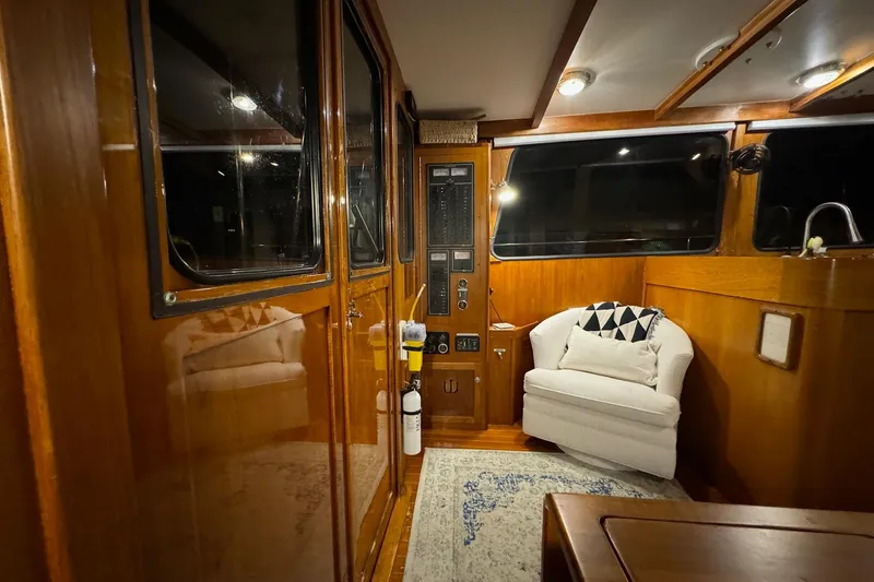 Slide: The Image of Interior of 1987 Lyman-Morse Hunt 42 yacht with wooden paneling and cozy seating. - 34