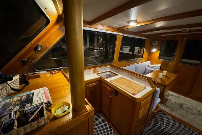 Slide: The Image of Interior of 1987 Lyman-Morse Hunt 42 yacht with wooden cabinetry and cozy seating area. - 37