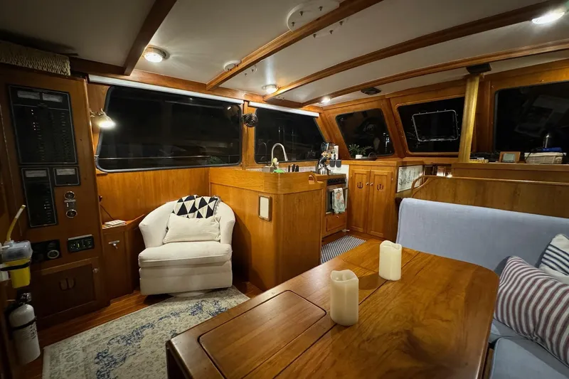Slide: The Image of Cozy interior of 1987 Lyman-Morse Hunt 42 yacht with wooden furnishings and seating area. - 4
