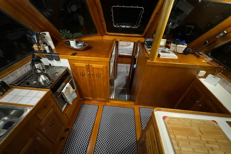 Slide: The Image of Interior of 1987 Lyman-Morse Hunt 42 yacht with wooden cabinetry and kitchen amenities. - 41