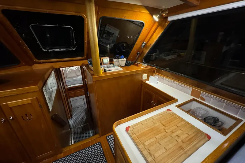 Slide: The Image of Interior of 1987 Lyman-Morse Hunt 42 yacht with wooden cabinetry and kitchen area. - 42