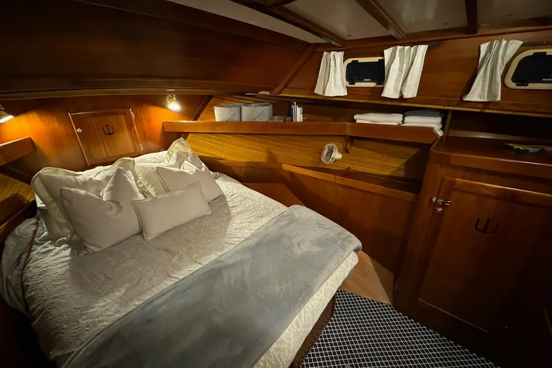 Slide: The Image of Cozy cabin interior of 1987 Lyman-Morse Hunt 42 yacht with wooden finish and plush bedding. - 55