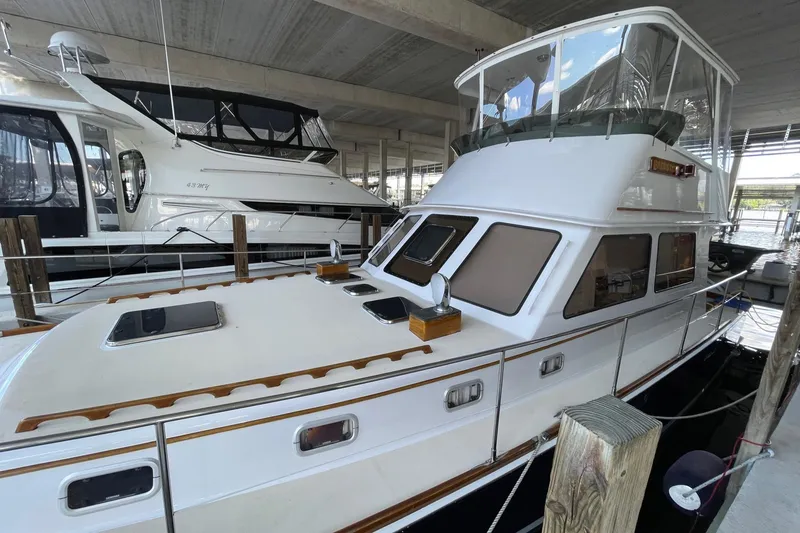 Slide: The Image of 1987 Lyman-Morse Hunt 42 yacht docked in a marina, featuring classic design elements. - 63