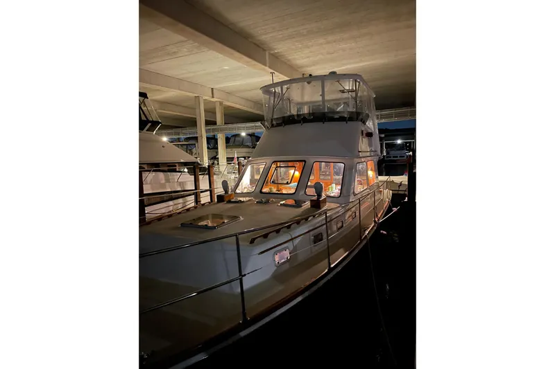 Slide: The Image of 1987 Lyman-Morse Hunt 42 yacht docked in a dimly lit marina. - 64