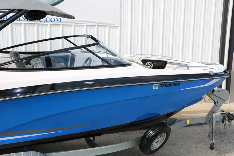 Slide: The Image of 2017 Yamaha Boats AR240 HO in blue on trailer, side view. - 17
