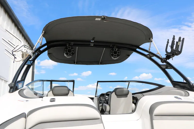 Slide: The Image of 2017 Yamaha Boats AR240 HO interior with canopy and speakers against blue sky. - 18