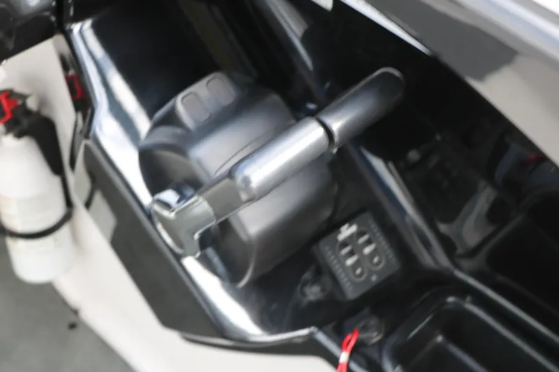 Slide: The Image of Throttle control of a 2017 Yamaha Boats AR240 HO with fire extinguisher nearby. - 34