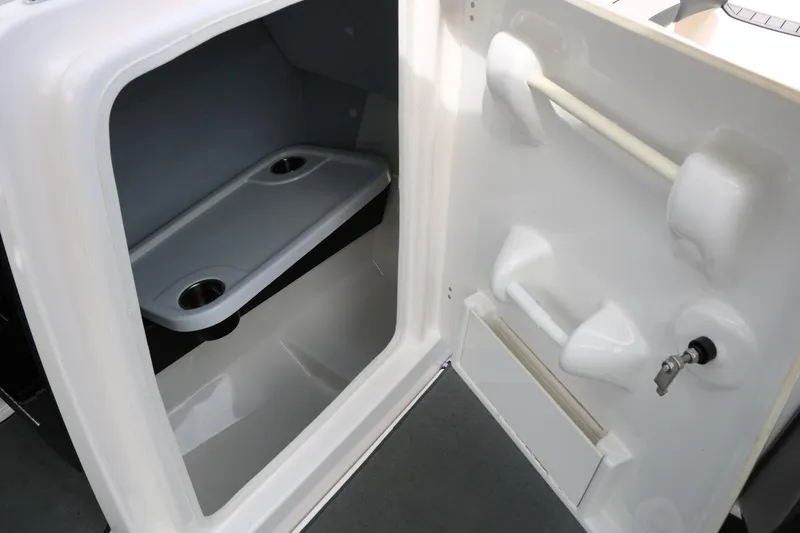 Slide: The Image of 2017 Yamaha Boats AR240 HO interior storage compartment with cup holders and sleek design. - 38