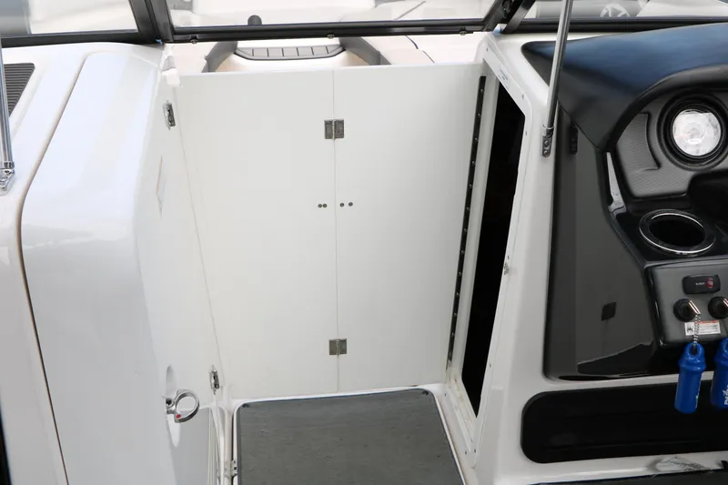 Slide: The Image of 2017 Yamaha Boats AR240 HO interior cockpit with storage compartment and control panel. - 43