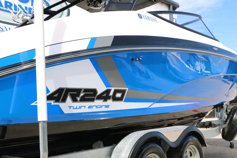 Slide: The Image of 2017 Yamaha Boats AR240 HO, blue and white design, twin engine, on trailer. - 6