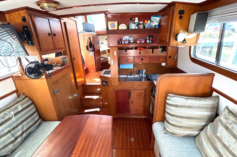 Slide: The Image of Interior of a 1987 Transpacific Marine Eagle 32 Trawler with wooden cabinetry and cozy seating. - 23