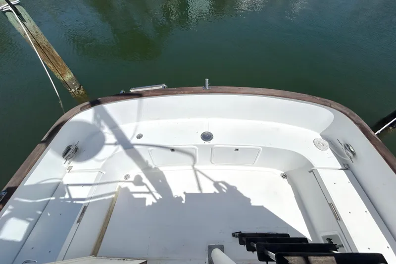 Slide: The Image of 1987 Transpacific Marine Eagle 32 Trawler deck, featuring spacious white interior and wooden trim. - 14