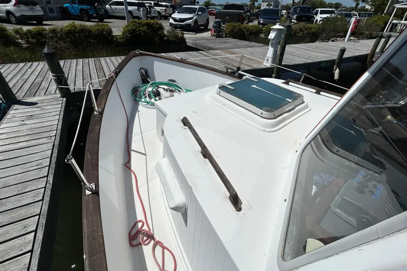 Slide: The Image of 1987 Transpacific Marine Eagle 32 Trawler docked, showcasing deck and cabin details. - 3