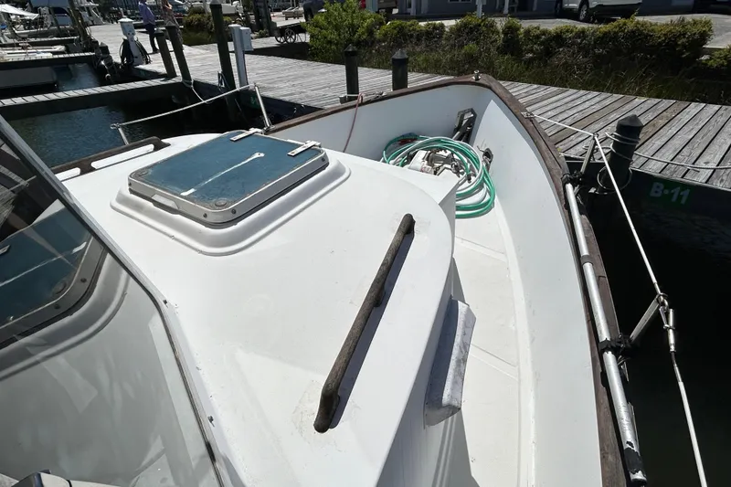 Slide: The Image of 1987 Transpacific Marine Eagle 32 Trawler docked, showcasing deck and hatch details. - 4