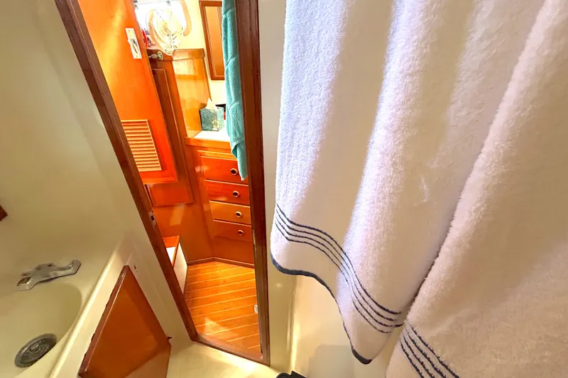 Slide: The Image of 1987 Transpacific Marine Eagle 32 Trawler bathroom with wooden cabinetry and white towel. - 49