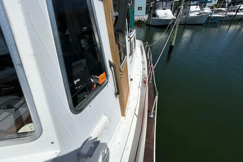 Slide: The Image of 1987 Transpacific Marine Eagle 32 Trawler docked at marina, side view. - 6