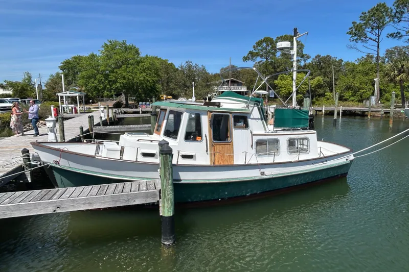 The Image of 1987 Transpacific Marine Trawler docked at a marina on a sunny day. - 1