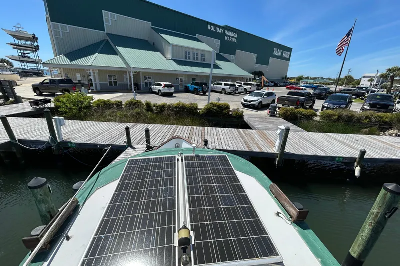 Slide: The Image of 1987 Transpacific Marine Eagle 32 Trawler docked at Holiday Harbor Marina with solar panels. - 13