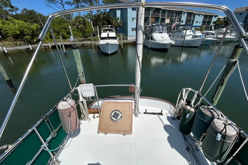Slide: The Image of 1987 Transpacific Marine Eagle 32 Trawler docked at marina, surrounded by boats and buildings. - 14