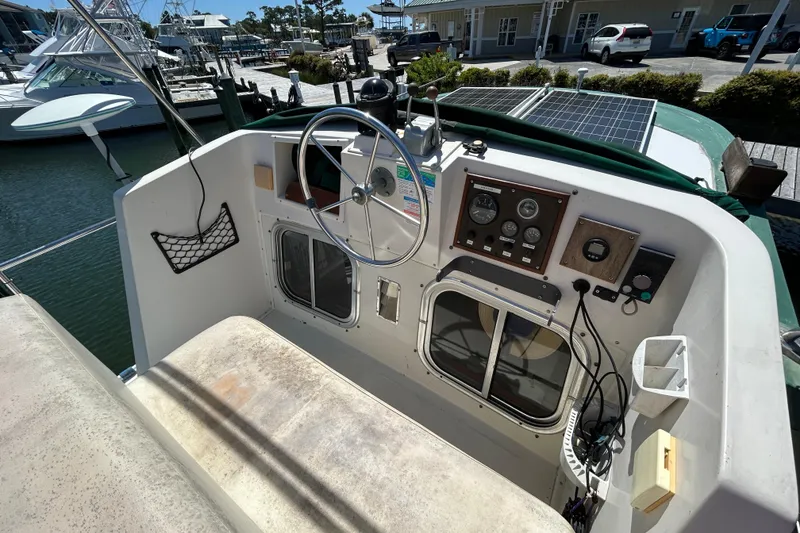 Slide: The Image of Helm of 1987 Transpacific Marine Eagle 32 Trawler with steering wheel and control panel. - 18