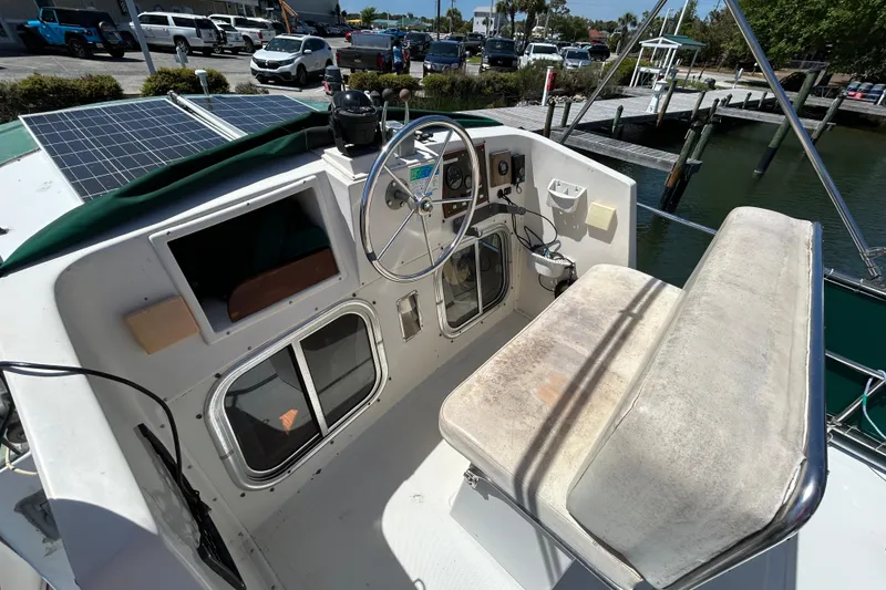 Slide: The Image of 1987 Transpacific Marine Eagle 32 Trawler helm with solar panels and dock view. - 19