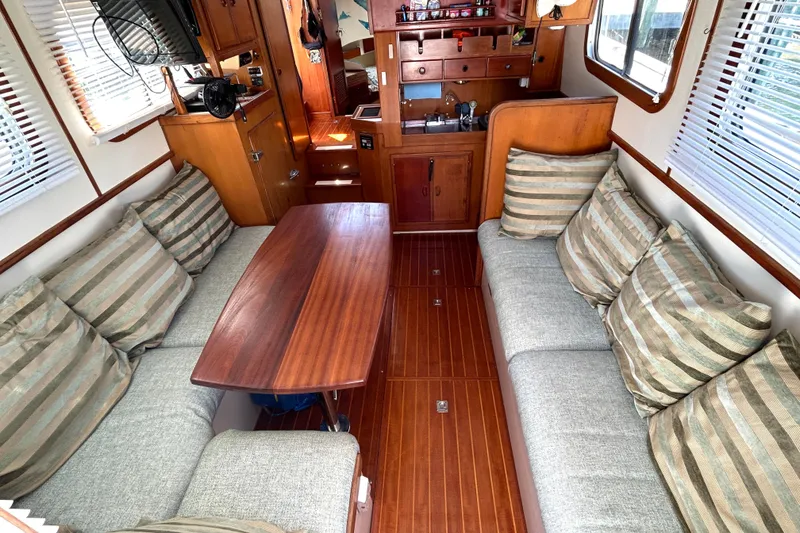 Slide: The Image of Interior of 1987 Transpacific Marine Eagle 32 Trawler with cozy seating and wooden table. - 21